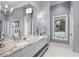 Elegant bathroom featuring double sinks, granite countertops, and natural light at 1112 Preserve Point Dr, Winter Park, FL 32789