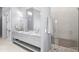 Elegant bathroom featuring double sinks, granite countertops, and a standup shower at 1112 Preserve Point Dr, Winter Park, FL 32789