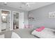 Bedroom features a study area, ensuite bathroom, and neutral decor at 1112 Preserve Point Dr, Winter Park, FL 32789