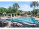 Community pool with seating, cabana, and tropical landscaping, creating a resort-like atmosphere at 1112 Preserve Point Dr, Winter Park, FL 32789