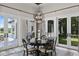 Elegant dining room with decorative chandelier and views of the outdoor area at 1112 Preserve Point Dr, Winter Park, FL 32789