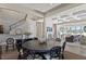Open-concept dining area with a circular table, decorative chairs, and staircase at 1112 Preserve Point Dr, Winter Park, FL 32789