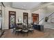 Elegant dining room featuring a round table, ornate doors, and a staircase, perfect for gatherings at 1112 Preserve Point Dr, Winter Park, FL 32789