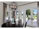 Bright dining area with a view of the pool and lake through large windows at 1112 Preserve Point Dr, Winter Park, FL 32789
