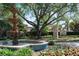 A tiered water fountain is the focal point of the Windsong community entrance at 1112 Preserve Point Dr, Winter Park, FL 32789