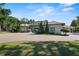 Expansive property showcasing a two-story home, verdant lawns, and mature landscaping, all surrounded by lush greenery at 1112 Preserve Point Dr, Winter Park, FL 32789