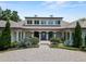 Elegant home showcasing its manicured front yard, circular driveway, and grand entrance with classic architectural details at 1112 Preserve Point Dr, Winter Park, FL 32789