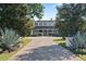 View of an elegant home, framed by mature trees, with a large circular driveway and landscaped entrance at 1112 Preserve Point Dr, Winter Park, FL 32789