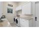 Laundry room features a sink, washer and dryer, and built-in cabinets at 1112 Preserve Point Dr, Winter Park, FL 32789
