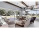Comfortable living room features sofas, beamed ceiling, and a view of the pool at 1112 Preserve Point Dr, Winter Park, FL 32789