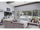 Relax in this stylish living room with a view of the pool area through sliding glass doors at 1112 Preserve Point Dr, Winter Park, FL 32789
