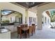 Outdoor kitchen and dining space with stainless steel grill and granite countertops at 1112 Preserve Point Dr, Winter Park, FL 32789