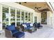 Charming outdoor patio with comfortable seating, ceiling fans and views of the lake at 1112 Preserve Point Dr, Winter Park, FL 32789