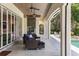 Relaxing outdoor patio with a beautiful lake view, plenty of seating and an outdoor fireplace at 1112 Preserve Point Dr, Winter Park, FL 32789