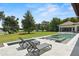 Inviting backyard pool and spa with lounge chairs overlooking lush lawn and picturesque lake views at 1112 Preserve Point Dr, Winter Park, FL 32789