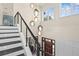 Staircase with dark wood stairs and wood and metal railing at 1112 Preserve Point Dr, Winter Park, FL 32789