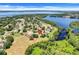 Aerial view of a residential community surrounded by lakes and lush greenery, with a home marked by a pin at 11602 Graces Way, Clermont, FL 34711