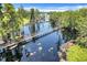 Aerial view of bridges crossing a lake surrounded by lush greenery at 11602 Graces Way, Clermont, FL 34711