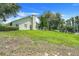 Expansive backyard showcases well-manicured lawn and mature trees providing privacy at 11602 Graces Way, Clermont, FL 34711