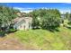 Aerial view showcases the home's large backyard, landscaping, and mature trees at 11602 Graces Way, Clermont, FL 34711