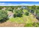 Aerial view showcases the home's large backyard, landscaping, and proximity to a lake at 11602 Graces Way, Clermont, FL 34711