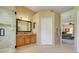 Bathroom with glass shower, wooden cabinets, and a vanity sink at 11602 Graces Way, Clermont, FL 34711