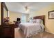 Bright and sunny bedroom with ceiling fan, dresser and plush bed at 11602 Graces Way, Clermont, FL 34711