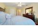 Bedroom with a large bed, ceiling fan and a dresser at 11602 Graces Way, Clermont, FL 34711