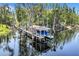 Picturesque boat dock with a covered slip in a serene, tree-lined waterfront setting at 11602 Graces Way, Clermont, FL 34711