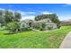Charming single-story home featuring a lush green lawn and meticulously manicured landscaping at 11602 Graces Way, Clermont, FL 34711