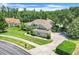 Beautiful single-story home showcasing a well-manicured lawn, lush landscaping, and a brick driveway at 11602 Graces Way, Clermont, FL 34711