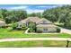 Charming single-story home featuring a lush green lawn and meticulously manicured landscaping at 11602 Graces Way, Clermont, FL 34711