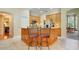 Kitchen island featuring wooden cabinets, a countertop, and seating space at 11602 Graces Way, Clermont, FL 34711