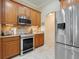 Spacious kitchen with stainless steel appliances and wooden cabinets at 11602 Graces Way, Clermont, FL 34711