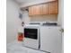 Spacious laundry room featuring a washing machine, dryer and built in cabinets at 11602 Graces Way, Clermont, FL 34711