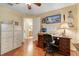 Home office with desk, cabinets, and hardwood floors at 11602 Graces Way, Clermont, FL 34711