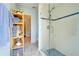 Walk-in shower with glass doors, white tiled walls and blue accent at 11602 Graces Way, Clermont, FL 34711