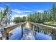 Picturesque walkway stretching across the water through the trees at 11602 Graces Way, Clermont, FL 34711