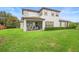 Spacious backyard features a green lawn, privacy landscaping, and a covered brick patio at 1365 Tappie Toorie Cir, Lake Mary, FL 32746