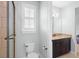Well-lit bathroom with granite-topped vanity, and walk-in shower with neutral tile at 1365 Tappie Toorie Cir, Lake Mary, FL 32746