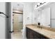 Beautiful bathroom with granite countertop vanity and walk-in shower with neutral tiling at 1365 Tappie Toorie Cir, Lake Mary, FL 32746