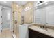 Bathroom with modern tiled shower and granite countertop vanity with a white sink and elegant fixtures at 1365 Tappie Toorie Cir, Lake Mary, FL 32746