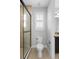 Bright bathroom with modern toilet, white shutters, and beige tiled flooring at 1365 Tappie Toorie Cir, Lake Mary, FL 32746