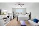 Inviting bedroom features a ceiling fan, white shutters, and a neutral color scheme at 1365 Tappie Toorie Cir, Lake Mary, FL 32746