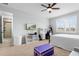 Bedroom with ensuite bathroom, white shutters, ceiling fan, and neutral decor at 1365 Tappie Toorie Cir, Lake Mary, FL 32746
