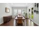 Formal dining room with large table, wood floors, plenty of windows, and natural light at 1365 Tappie Toorie Cir, Lake Mary, FL 32746