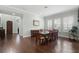Dining room with large table, hardwood floors, natural light and entry to the home at 1365 Tappie Toorie Cir, Lake Mary, FL 32746