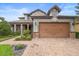 Beautiful home with a brick-paved driveway and stone-accented facade at 1365 Tappie Toorie Cir, Lake Mary, FL 32746