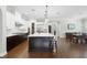 Open-concept kitchen with stainless appliances, large island, and hardwood floors, adjacent to dining area at 1365 Tappie Toorie Cir, Lake Mary, FL 32746