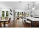 Spacious open-concept kitchen and living area with hardwood floors and modern lighting at 1365 Tappie Toorie Cir, Lake Mary, FL 32746